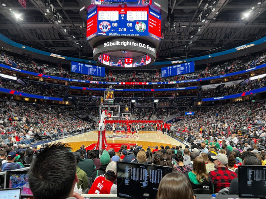 a crowd of people watching a basketball game