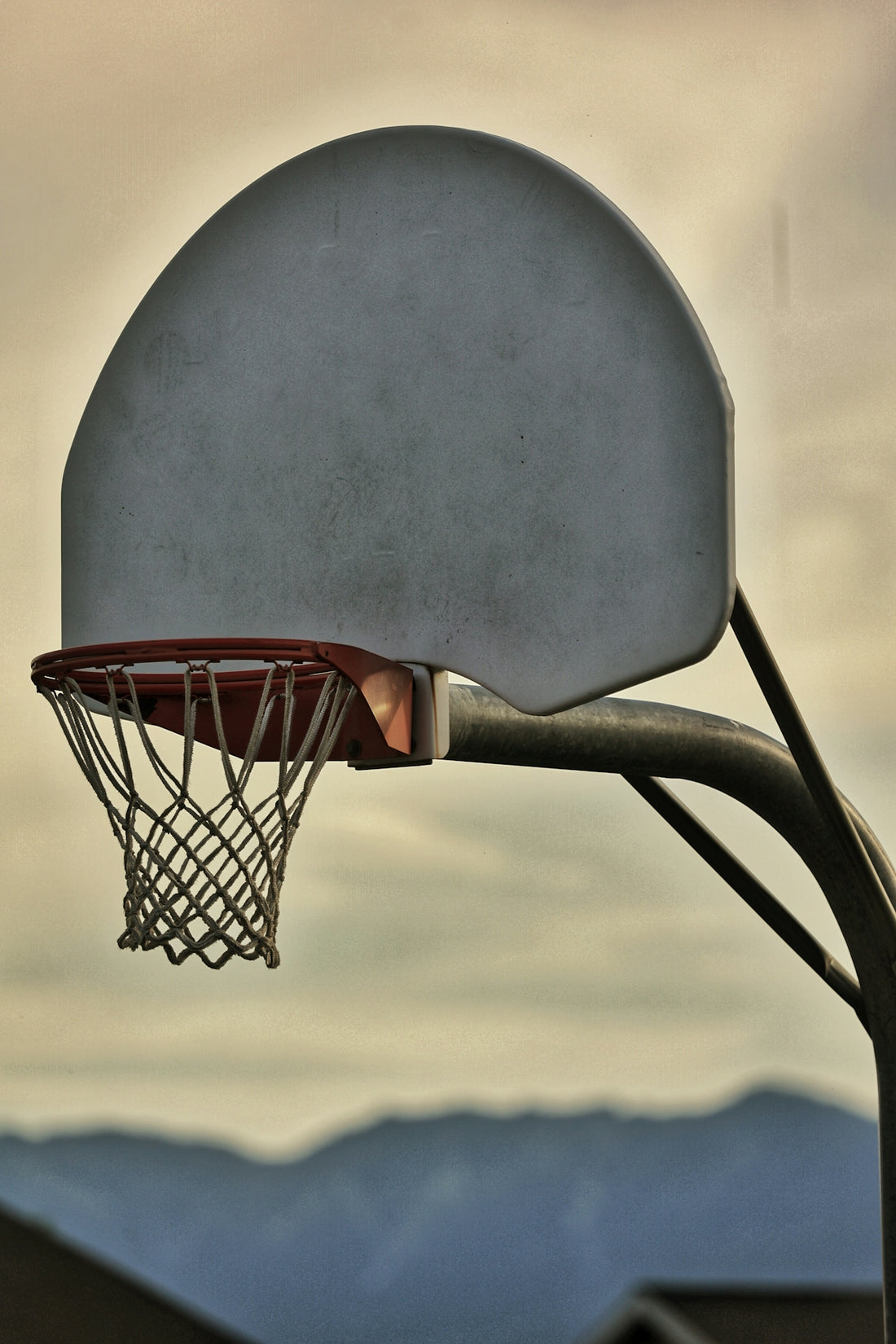 a basketball going through the rim of a basketball hoop