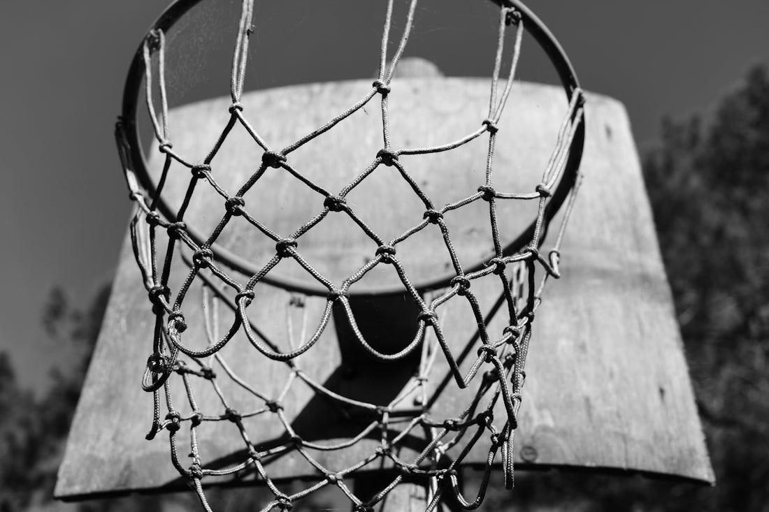 a black and white photo of a basketball net