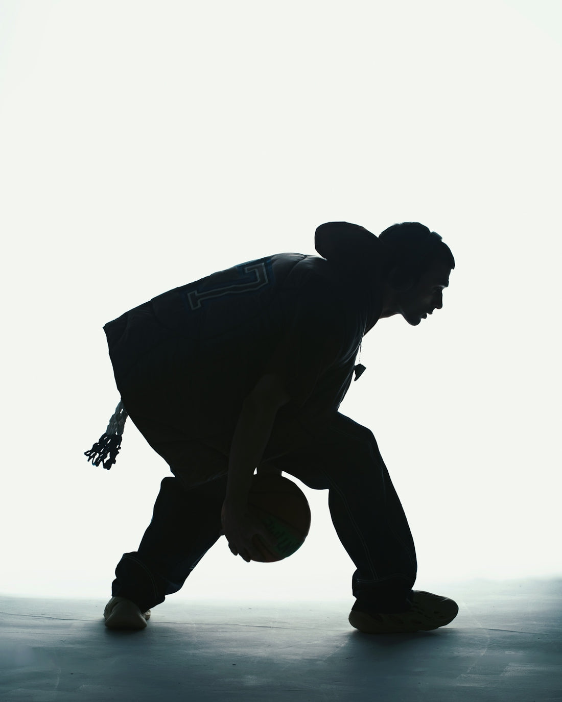 A silhouette of a man holding a basketball
