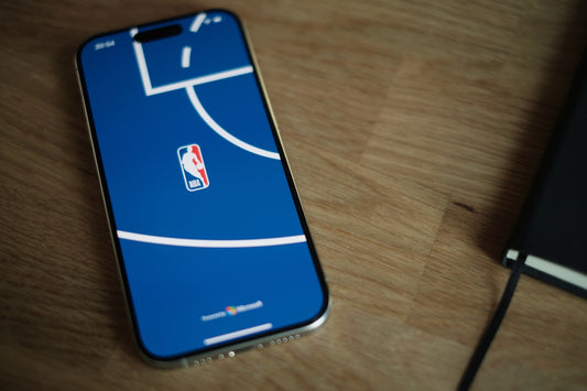 A cell phone sitting on top of a wooden table