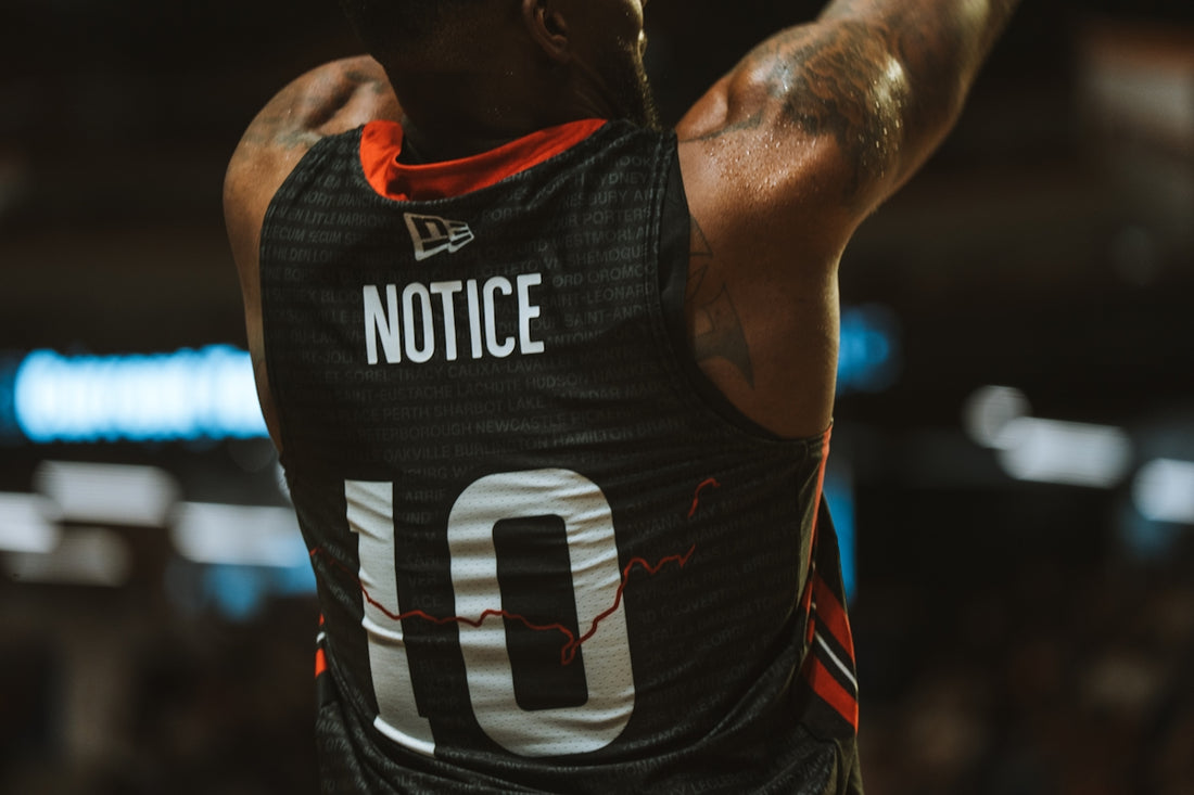 A basketball player with notice on his jersey.