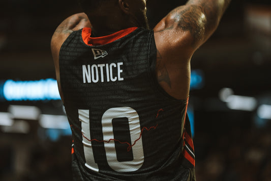 A basketball player with notice on his jersey.