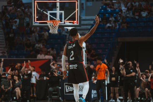 A basketball player celebrates after making a basket.